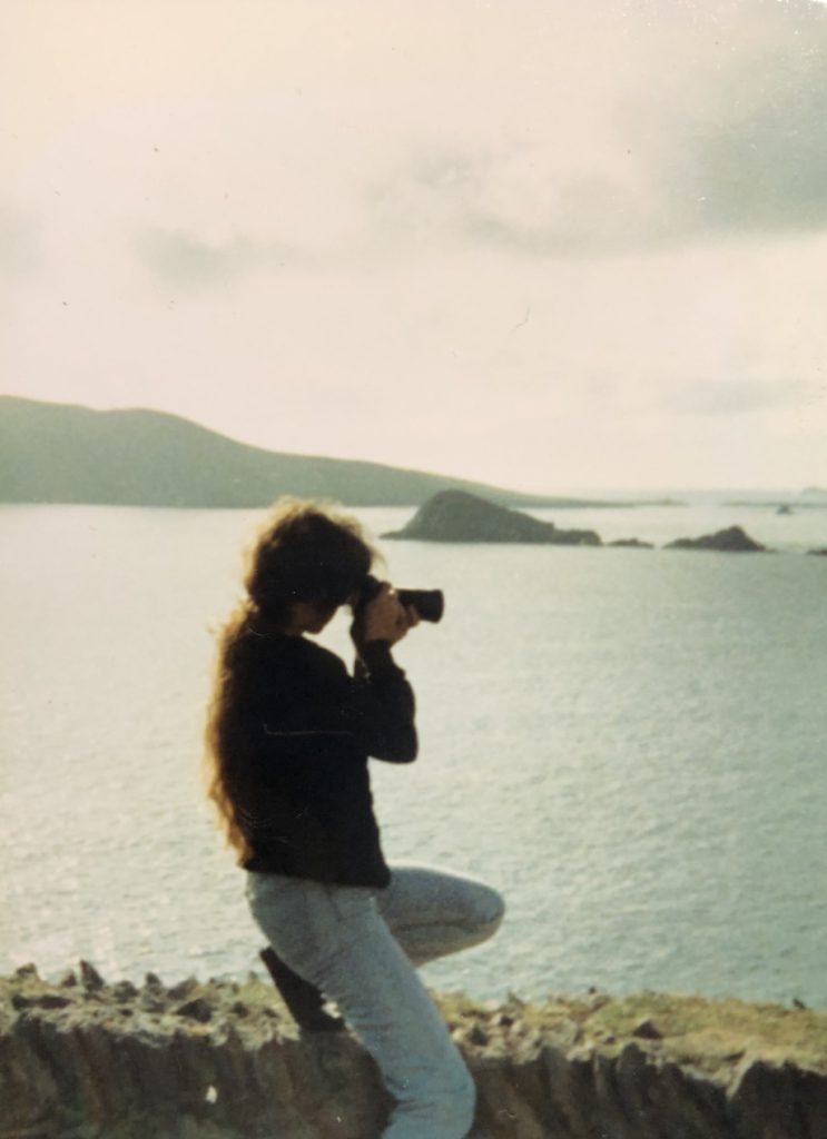 woman aiming camera seaward